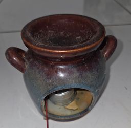 Vintage ceramic wax melt warmer, 4" diameter, 4.4" height, two side handles, cutout leaf design. Glazed brown and blue tones. Has leftover candle wax