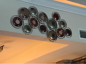 This Kirklands metallic wall hanging features interconnected circles with mirrored accents