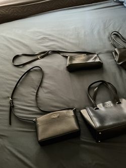 Two cross body purses and three hand purses.
