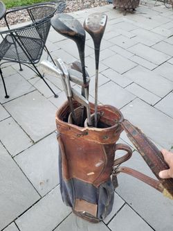 Vintage golf bag and variety of clubs
