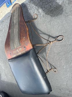 antique shoe-fitting or shoe-shine stool featuring twisted metal wire legs and an advertising backrest star brand shoes