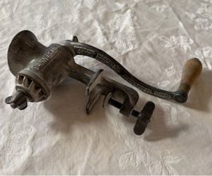 Vintage Universal manual food/meat grinder with hand crank and table-mount clamp.