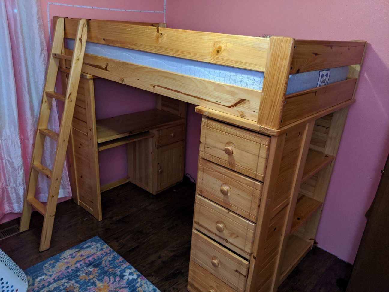 Twin loft bed with desk, drawers and book shelf.