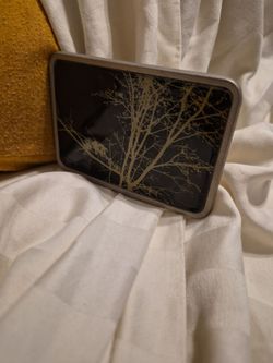 leafless winter tree branches against a dark background belt buckle