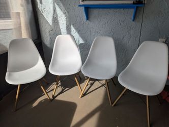 4 armless white plastic, wood and metal chairs