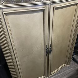 Tan or very light brown dish, bar or storage cabinet.