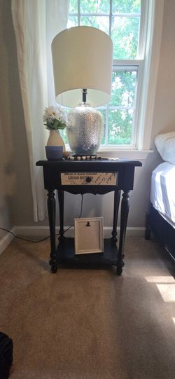 Black accent table with decorative graphic script.