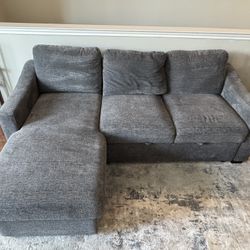 grey sectional with chaise, pullout ottoman, and electronic ports!