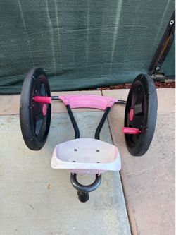 Radio Flyer Cyclone arm-powered ride-on toy, featuring a pink seat and ergonomic design for comfort.