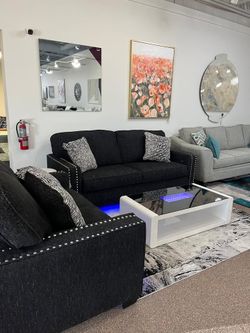 Stunning Sofa set features chic-coal upholstery, nailhead trim, LED light