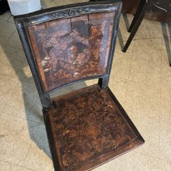 Antique wooden inlaid chair with engraved pictures on the seat and the inside back of the chair