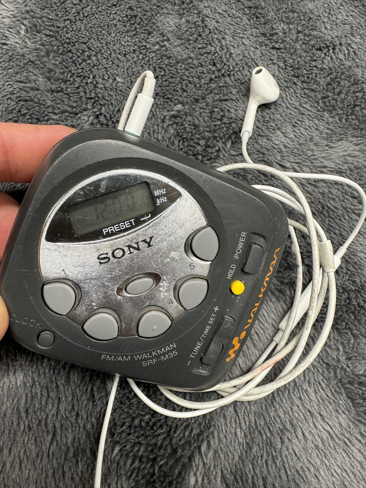 Vintage Compact Sony Am/FM Walkman with Apple Earpods w/Mic. Works great! Runs on Two AAA.