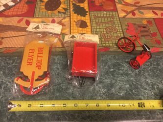 Three vintage Christmas items. Small metal tricycle, larger wooden and metal sled and still in original packaging smaller sled