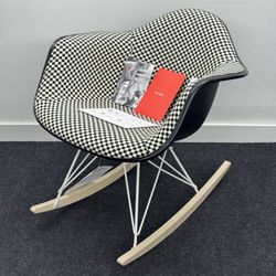 BRAND NEW HERMAN MILLER EAMES UPHOLSTERED MOLDED PLASTIC ARMCHAIR, ROCKER BASE. BLACK/WHITE CHECKERED PATTERN