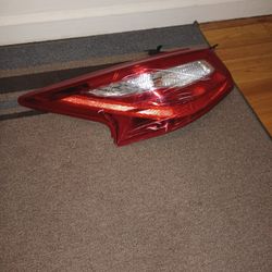 Rear Driver Side Headlight Assembly With A Bulbs On It