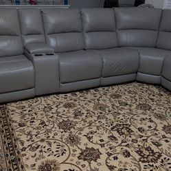 Spacious 7- Seat Sectional Sofa including 4 recliners plus 2 consoles with storage and cup holders for comfort.