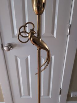 Vintage lamp with gold bird and milk glass shade.