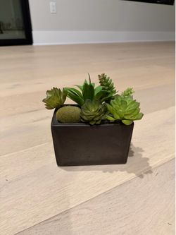 Small vase with fake green plants