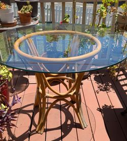 Rattan dining set with four chairs and glass top