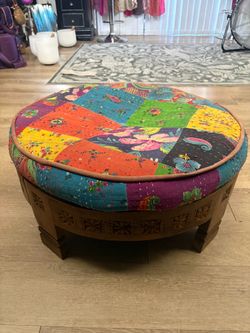 Large wooden footstool with patchwork cushion