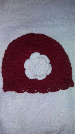 Red hat with white flower.