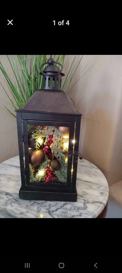 $10 Black Metal Lantern Filled with Artificial Pine with Bells And Lights. 
Batteries Not Included.