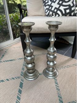 Two tall pottery barn, candle sticks.