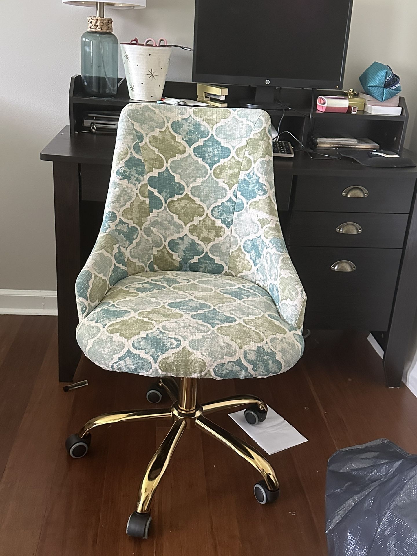 Espresso desk with a patterned desk chair.