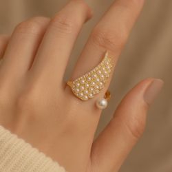 Elegant Gold Wing Pearl Open Ring | Adjustable Statement Ring with Crystals  	•	Unique wing-shaped design with pearl accents 	•	Sparkling rhinestones 