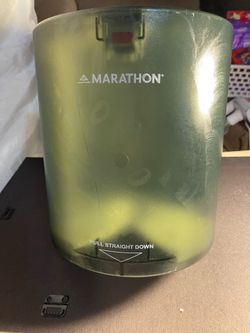 Marathon translucent green manual center-pull paper towel dispenser.