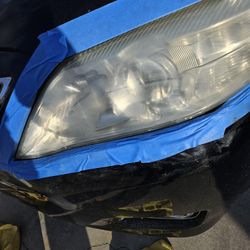 Renewed headlights and windshield with water Spots.