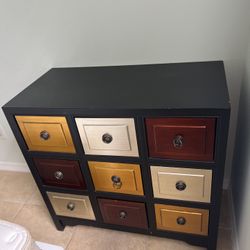 A Dresser/ Organizer With 9 Colorful Drawers