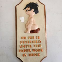 Vintage wall plaque featuring a humorous bathroom scene