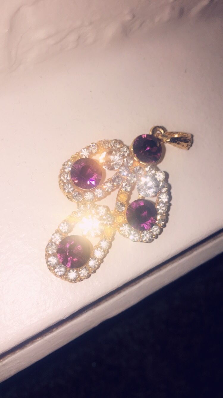 Gold charm with purple gems