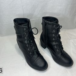 Brash black heeled combat boots. 
