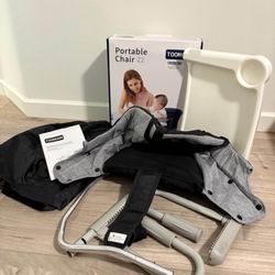 Portable baby highchair attaches to table with tray