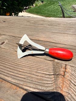 This vintage kitchen tool is a bell-shaped food chopper.