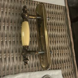 vintage-style brass and almond ceramic cabinet pull