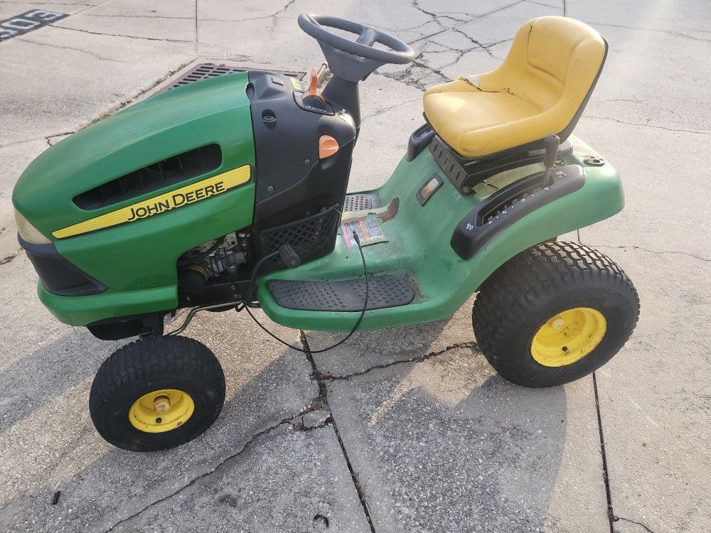 John Deere LA102 102 riding lawn mower for parts or repair. needs engine. complete less battery. comes with deck. not working