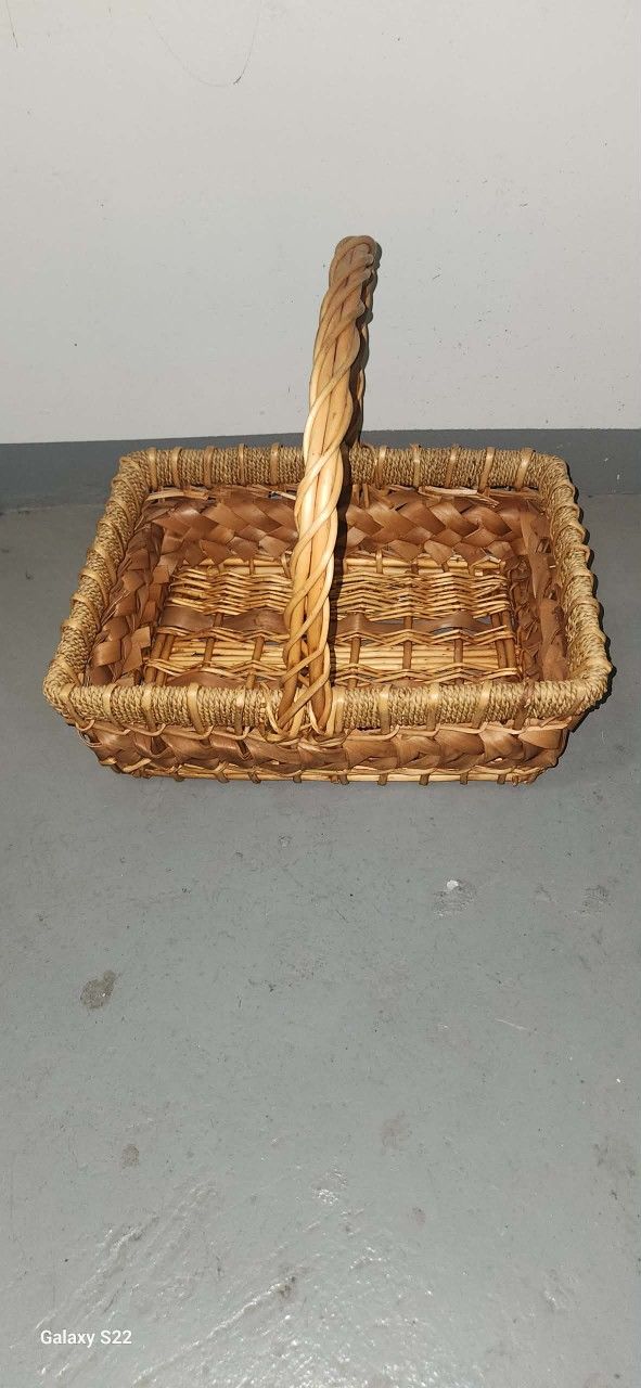 rectangular wicker basket with a braided handle.