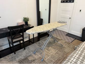 Ironing board and clothes drying rack.