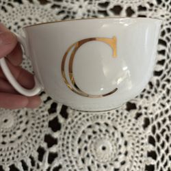 C  WHITE GLASS CUP WITH GOLD C AND RIM