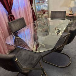 Glass dining room table with four chairs