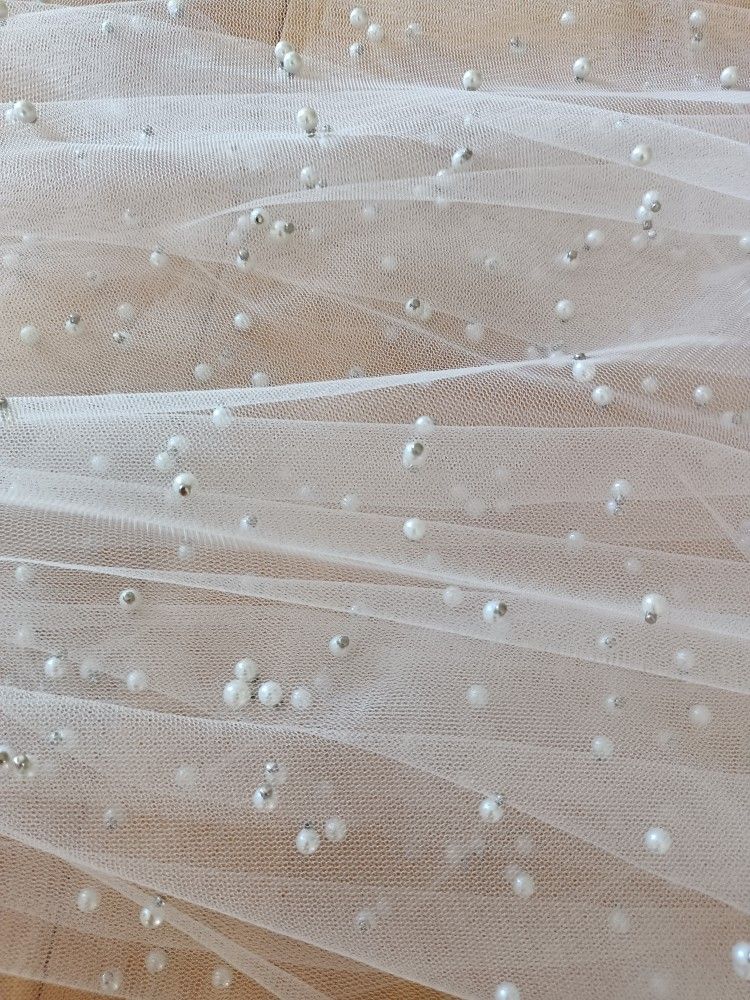 Bride accessories veil

Pearl Wedding Veil White Color hip Length made of tulle with pearl beads. Made with metal comb
Measurements
Width of comb 3.5 