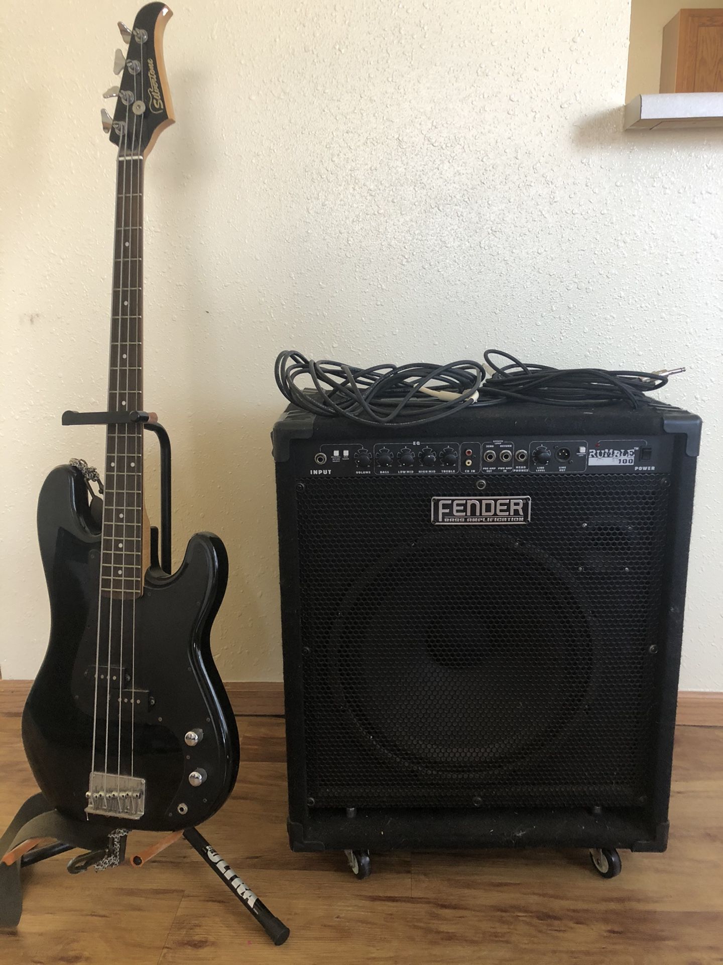 Fender 100 amp, bass guitar, and cords