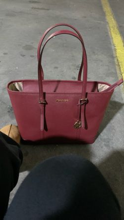 Michael Kors Jet Set Travel Large Saffiano Leather Tote Bag in a red or crimson color.