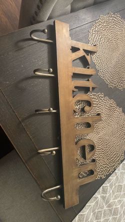 wooden wall-mounted "Kitchen" sign