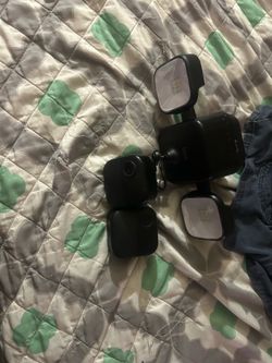 Two outdoor blink 4 cameras a sync module and a battery powered wire free floodlight