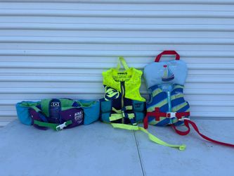 Set of 3 infant and child personal flotation devices (life vests) designed for water safety.