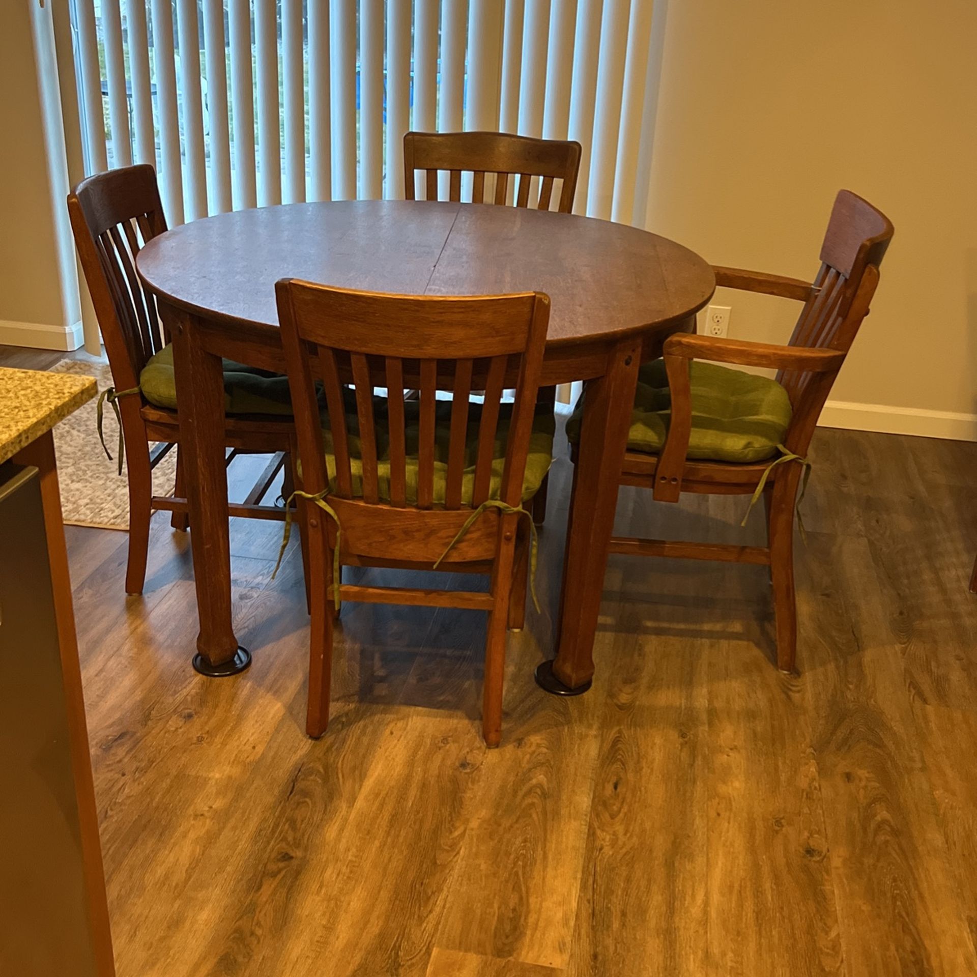 Turn of the century solid oak table with four chairs.